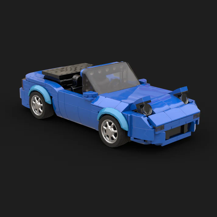 Blue model car used as a scale object during desk planning